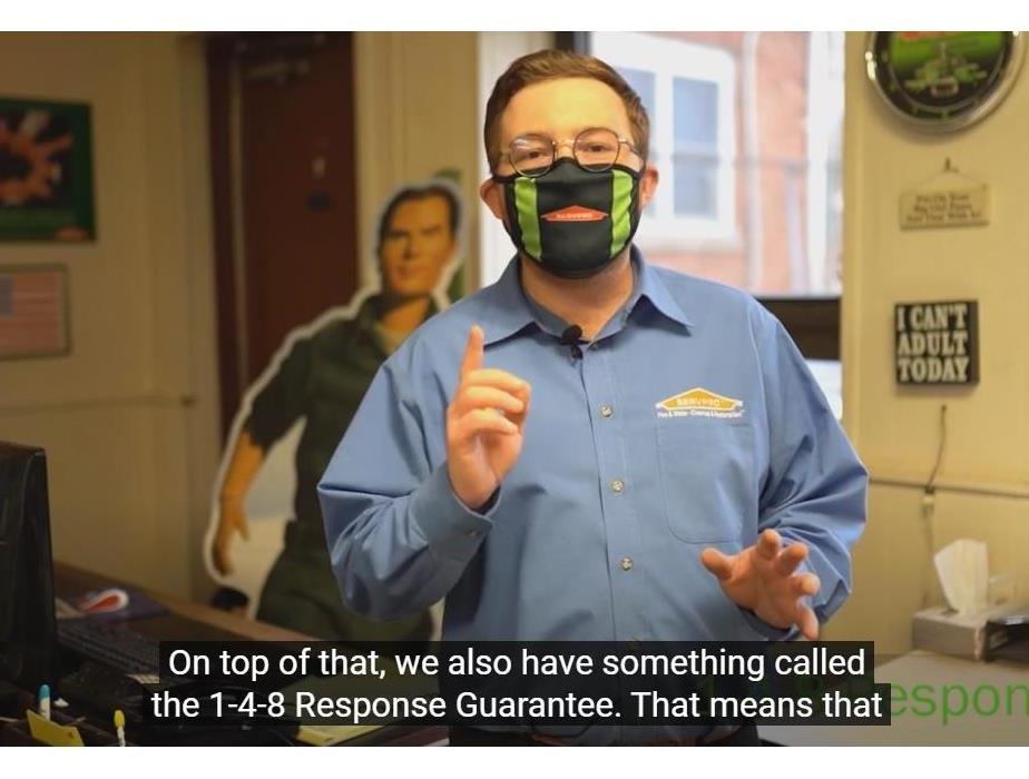 A man in a blue SERVPRO shirt speaking to the camera.